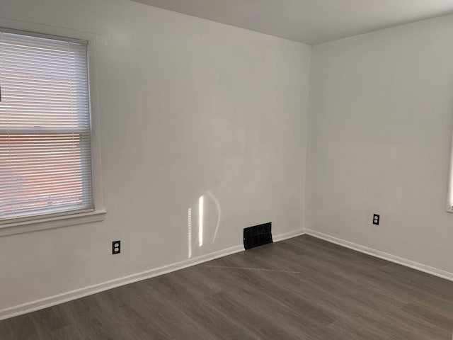 unfurnished room featuring dark hardwood / wood-style floors