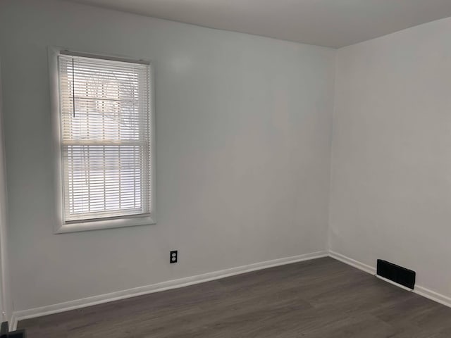 empty room featuring dark hardwood / wood-style flooring