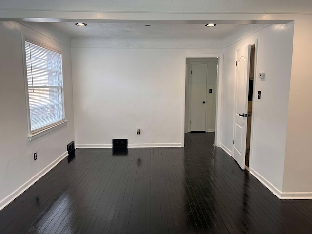 empty room with dark hardwood / wood-style flooring