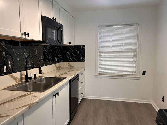 kitchen featuring light stone counters, sink, black appliances, and white cabinets