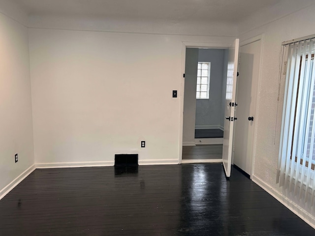 spare room featuring dark hardwood / wood-style flooring