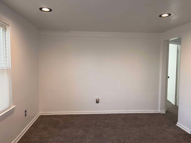 empty room with dark colored carpet