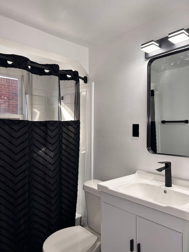 full bathroom featuring vanity, toilet, and shower / tub combo