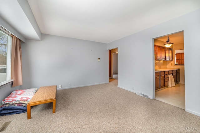 living area featuring light carpet