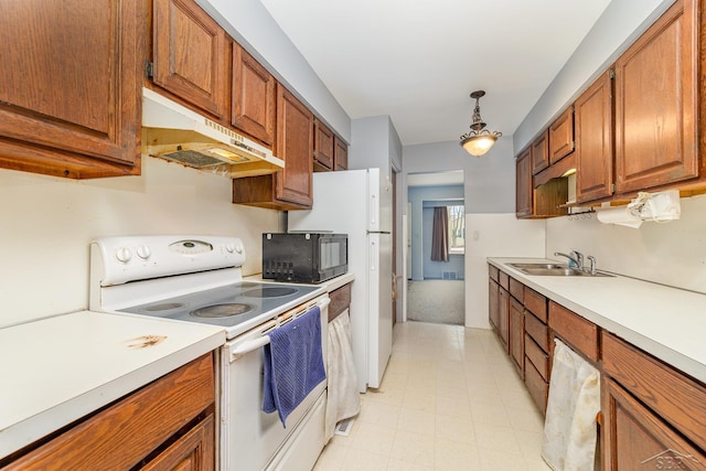 kitchen featuring sink, hanging light fixtures, and electric range