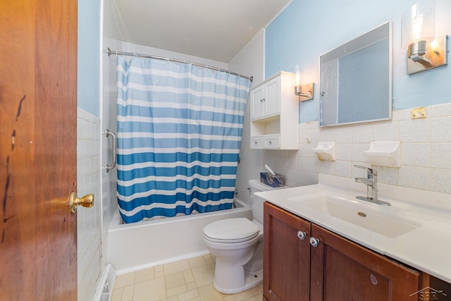 full bathroom with vanity, tile walls, shower / tub combo with curtain, and toilet