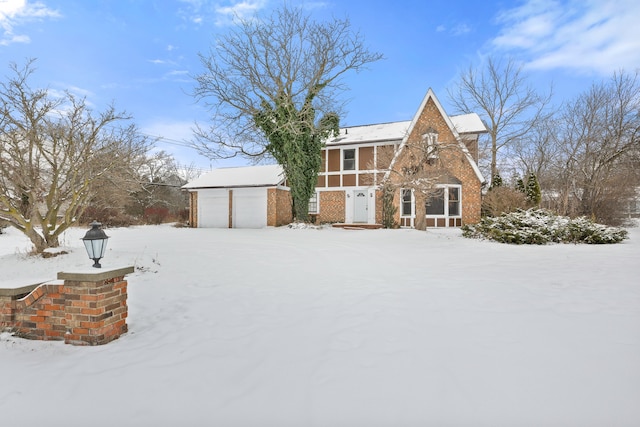 view of front of home featuring a garage and an outbuilding