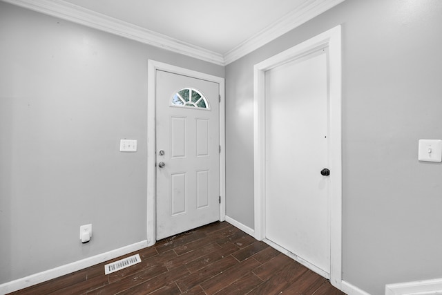 entrance foyer featuring ornamental molding and dark hardwood / wood-style floors