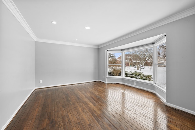 empty room featuring ornamental molding and dark wood-type flooring