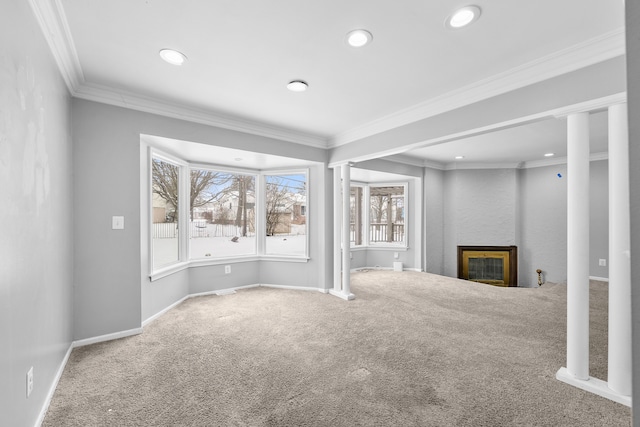 unfurnished living room with ornamental molding and carpet flooring