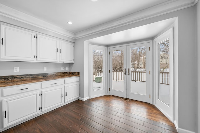 doorway featuring dark hardwood / wood-style flooring, ornamental molding, and french doors