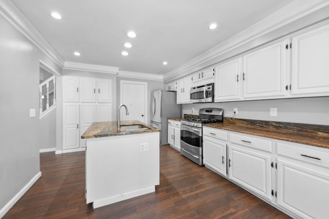 kitchen with white cabinetry, sink, a center island with sink, and appliances with stainless steel finishes