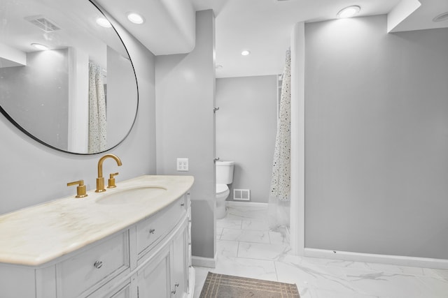 bathroom featuring vanity and toilet