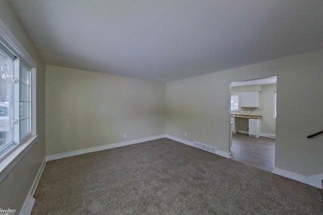 empty room with dark colored carpet