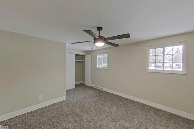 unfurnished bedroom with a closet, ceiling fan, and carpet flooring