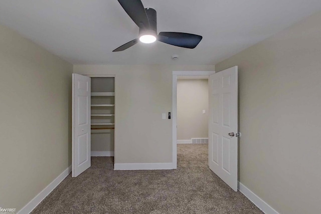 unfurnished bedroom featuring carpet flooring, ceiling fan, and a closet