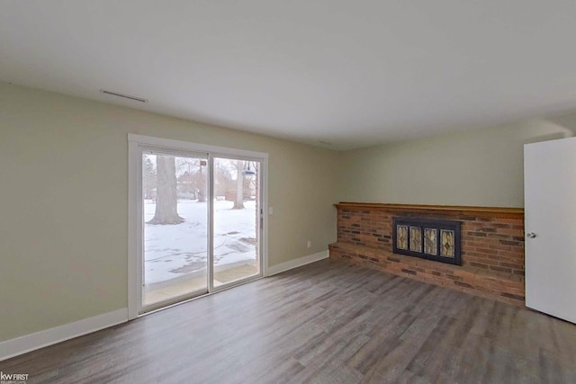 unfurnished living room featuring a fireplace and wood-type flooring