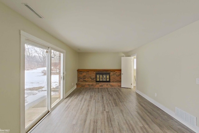 unfurnished living room with hardwood / wood-style flooring and a fireplace