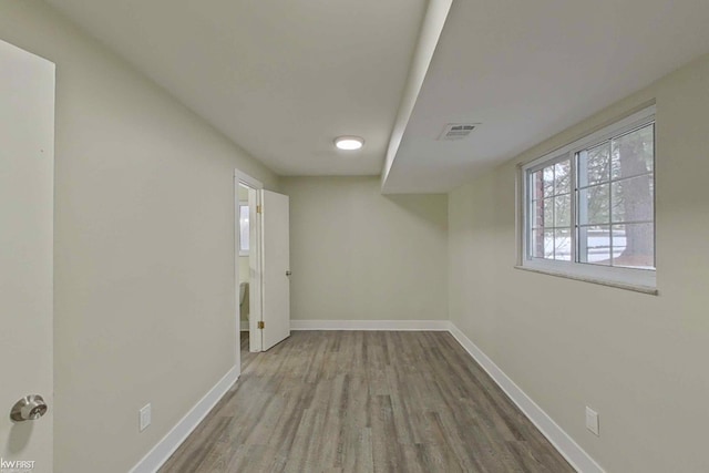 empty room with light hardwood / wood-style flooring