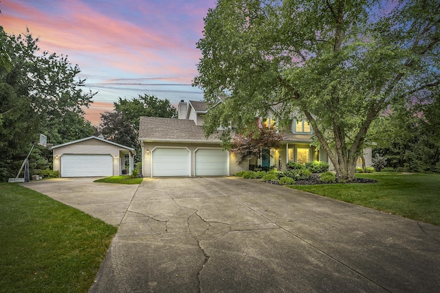 view of front of property featuring a yard and a garage