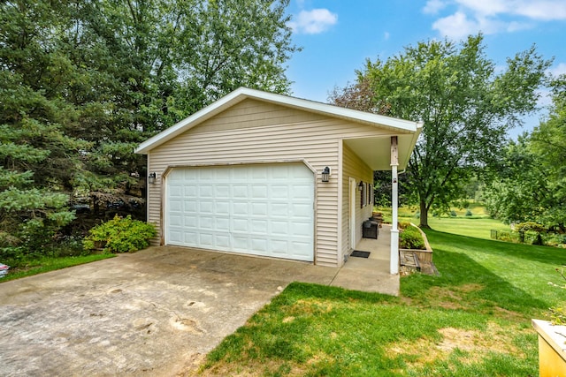 view of front of home with an outbuilding, a garage, and a front yard