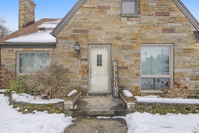 view of snow covered property entrance