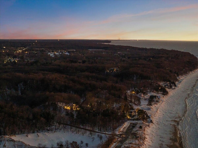 aerial view at dusk with a water view