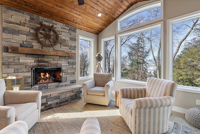 sunroom / solarium with wood ceiling, a fireplace, and vaulted ceiling