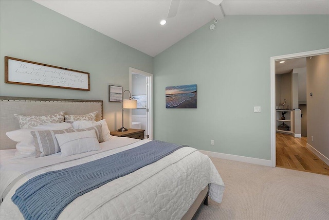 carpeted bedroom with lofted ceiling