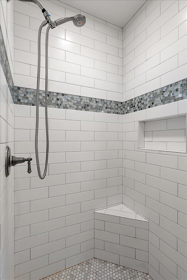 bathroom with tiled shower