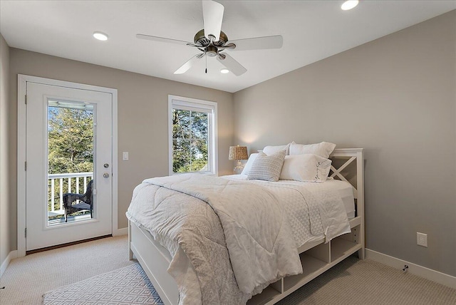 bedroom featuring multiple windows, access to outside, light colored carpet, and ceiling fan