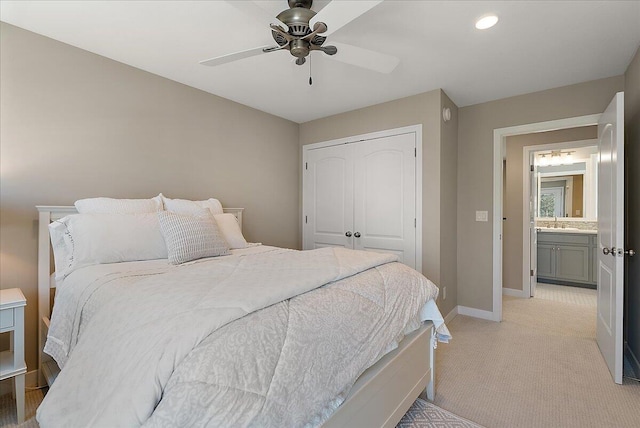 carpeted bedroom featuring sink, a closet, and ceiling fan