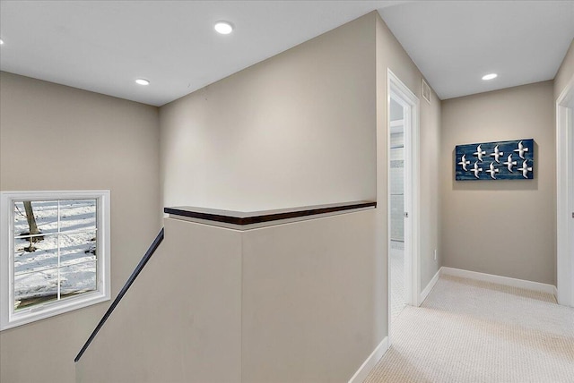 hallway with light colored carpet