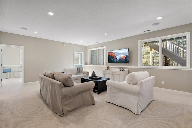 carpeted living room featuring a textured ceiling