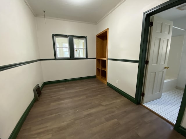 interior space featuring crown molding and dark wood-type flooring