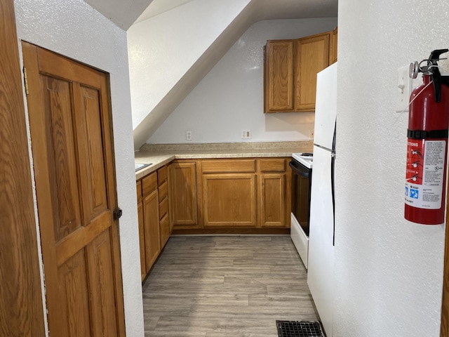 kitchen with electric range and light wood-type flooring