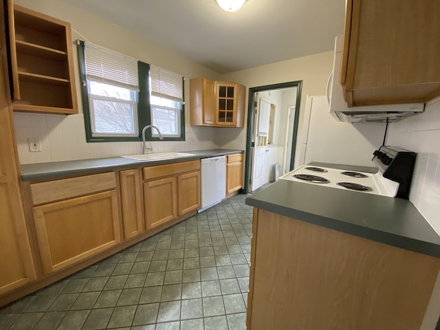 kitchen featuring white appliances, dark tile patterned floors, sink, and backsplash