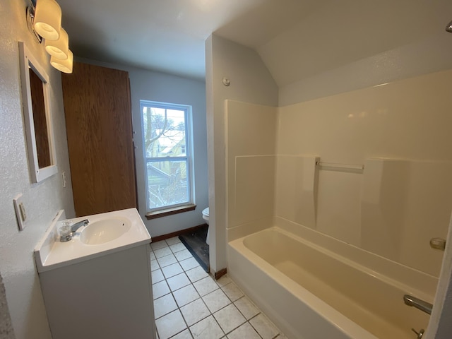 full bathroom featuring tile patterned floors, toilet, vaulted ceiling, shower / bathtub combination, and vanity