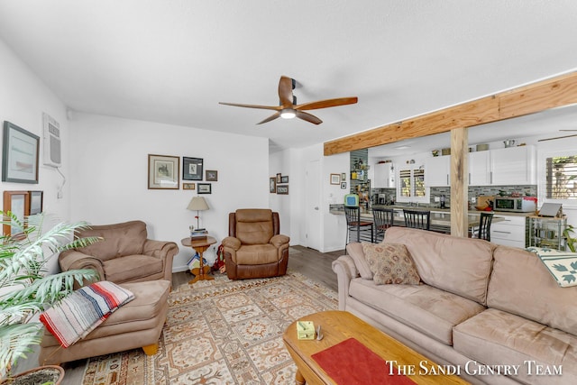 living room with ceiling fan and light hardwood / wood-style flooring