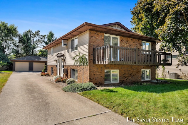 view of front of property with cooling unit, a garage, an outdoor structure, and a front yard