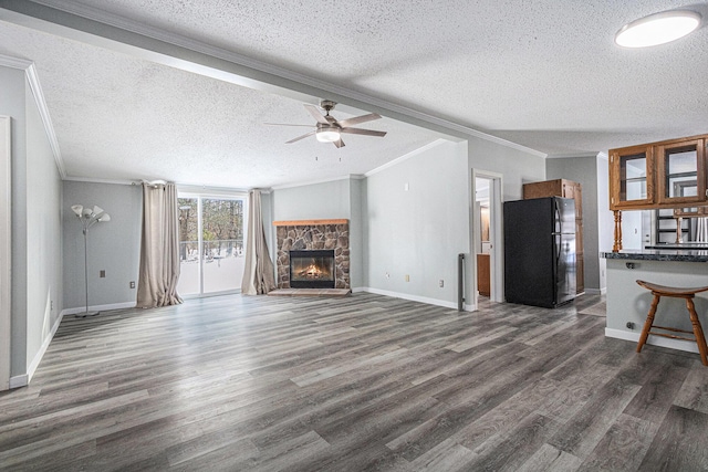 unfurnished living room with ceiling fan, ornamental molding, a fireplace, and dark hardwood / wood-style flooring