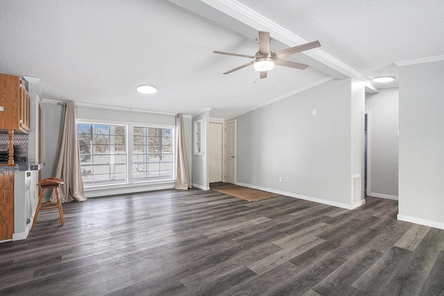 unfurnished living room with ornamental molding, dark hardwood / wood-style floors, and a textured ceiling