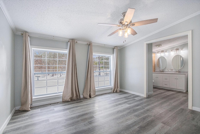 unfurnished bedroom with ornamental molding and hardwood / wood-style floors