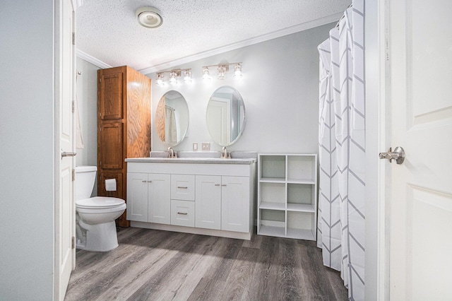 bathroom featuring crown molding, wood-type flooring, toilet, and a textured ceiling