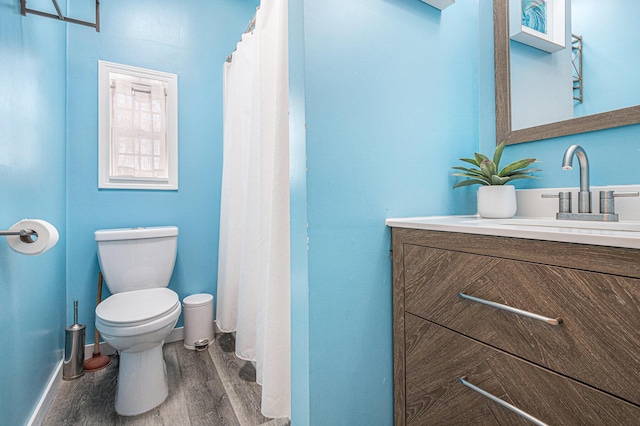 bathroom with vanity, hardwood / wood-style flooring, and toilet