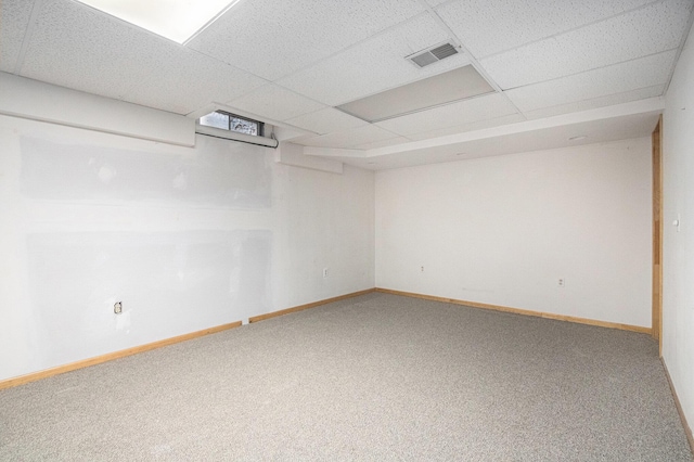 carpeted empty room featuring a paneled ceiling