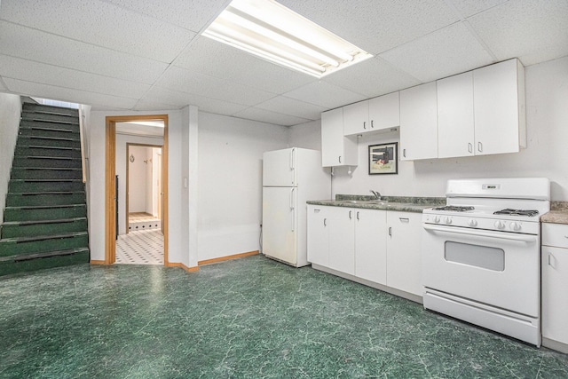 kitchen featuring sink, white appliances, a paneled ceiling, and white cabinets