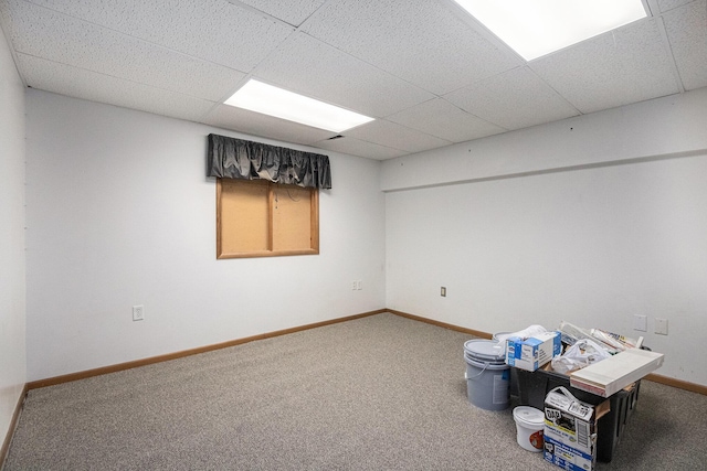 basement with carpet flooring and a drop ceiling