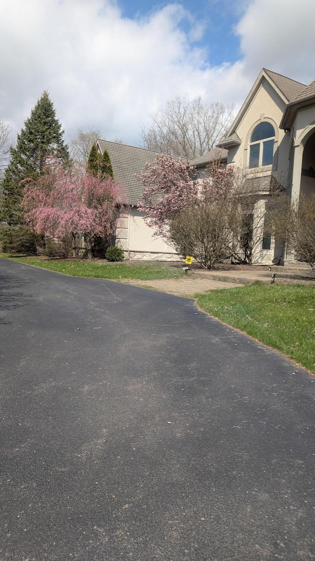 view of side of property with stone siding and stucco siding