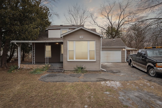 view of front facade featuring a garage, a porch, and a carport